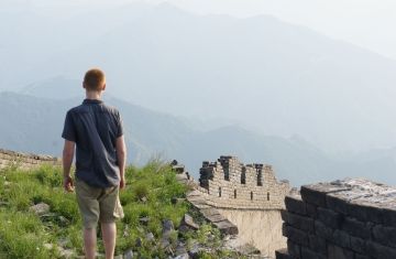 Study abroad student looking out on the Great Wall of China