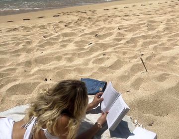 Tayler Baldwin studying on a beach in Ericeira, Portugal
