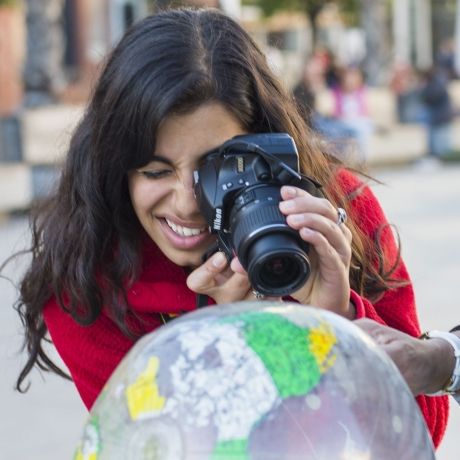 Seville student photographing an inflatable globe