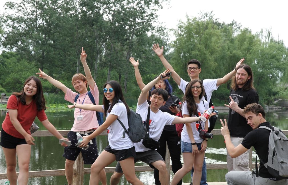 students posing by lake in beijing china