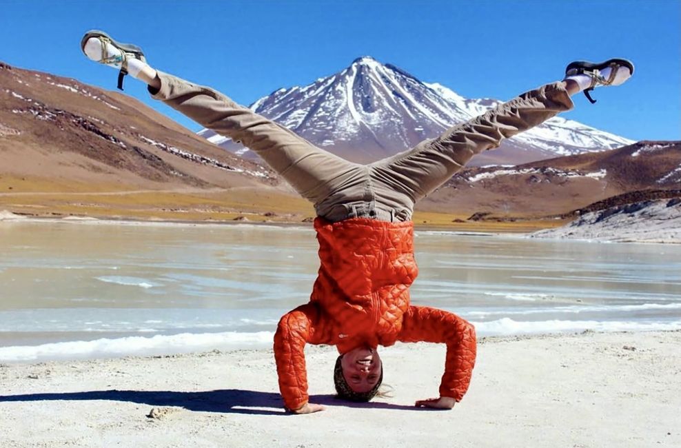 santiago ch student doing a headstand with mountain in background