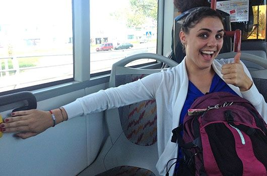 study abroad student with her backpack on the bus in spain