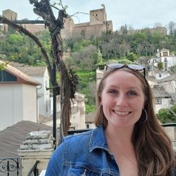 A picture of Elizabeth in front of the Alhambra in Granada, Spain.