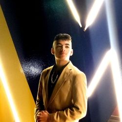 Dominick wearing a tan suit