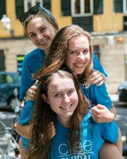 Global Navigator girls smiling on each other's shoulders