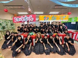 High school exchange student and classmates posing in front of booths