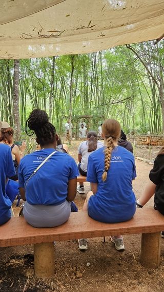 Students watch a Mayan ceremony to honor the God Chaac