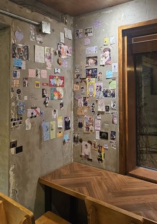 Wall covered in BTS decor in cafe