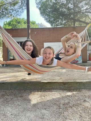 Three high school girls in a hammock 