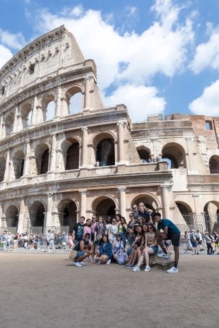 High school students posing in front of Colosseum in Rome 