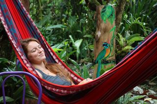 Student sleeping in a hammock in the rainforest of Monteverde