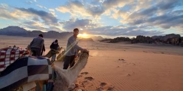 student with camel desert middle east