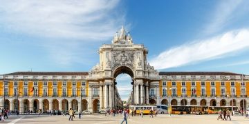 lisbon plaza with archway and yellow building