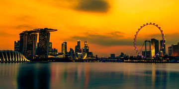 singapore skyline and ferris wheel at sunset