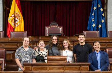 student interns standing in Spanish Parliament