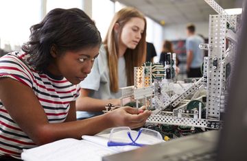 Two female interns work on an engineering project