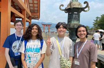 Kyoto students standing outside torii gate on Miyajima Island
