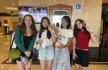 High school summer abroad students posing in front of elevator