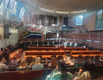 students sit inside the highest court in South Africa, Constitution Hill 