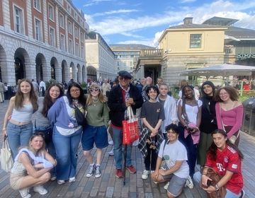 Students posing with Dicken's Walking Tour guide
