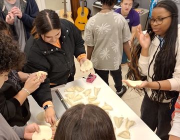 Students cut out and form pieces of dough.