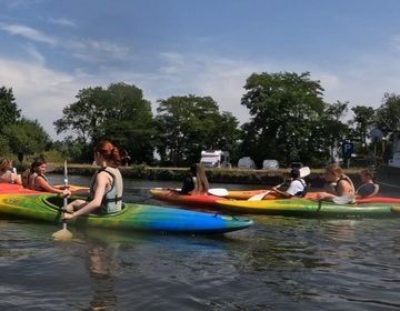 Kids kayaking on a river