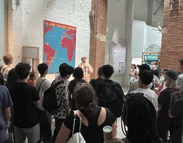 Students listen to a tour guide at the museum