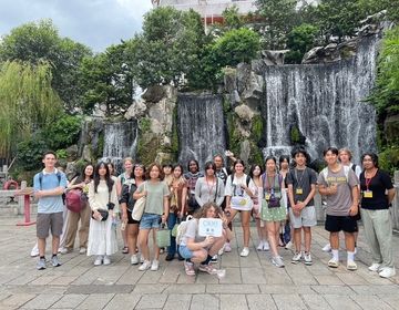 A group of students in front of a waterfall at longshan temple