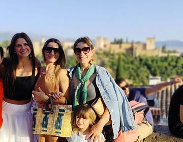 Host family and student with host siblings posing with castle in the background