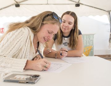 Students writing in café