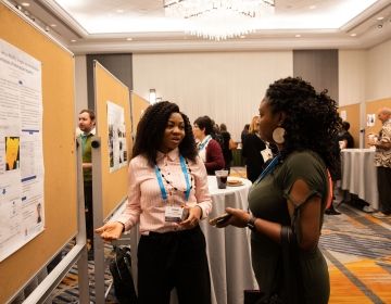 CIEE employees in front of a booth at a conference