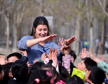 Teacher high-fiving her students