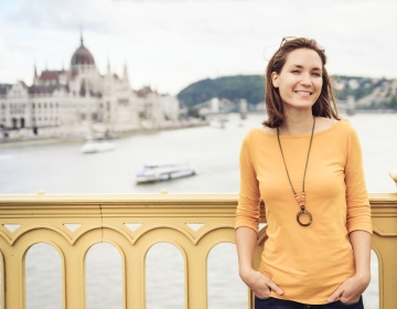 Woman on yellow bridge with Budapest in the background