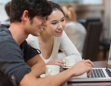 2 students working over laptop