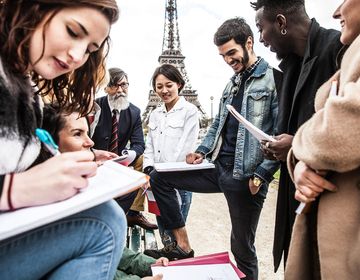 Students writing beside the Eiffel Tower in Paris