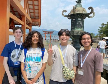 Kyoto students standing outside torii gate on Miyajima Island