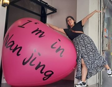 a person standing next to a heart