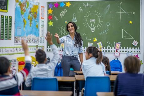 Teacher in front of class teaching her students