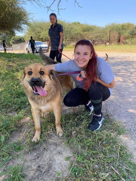 Student posing with dog in Gaborone