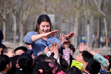 Teacher high-fiving her students