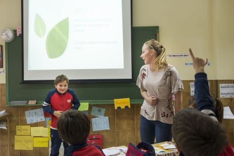 Teacher and student in front of the class presenting