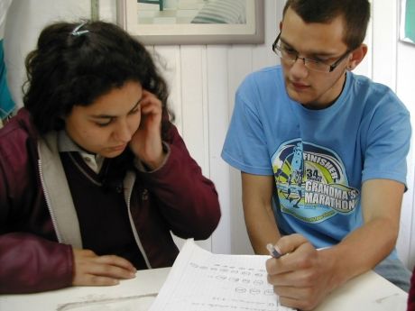 Teacher and student working on assignment together