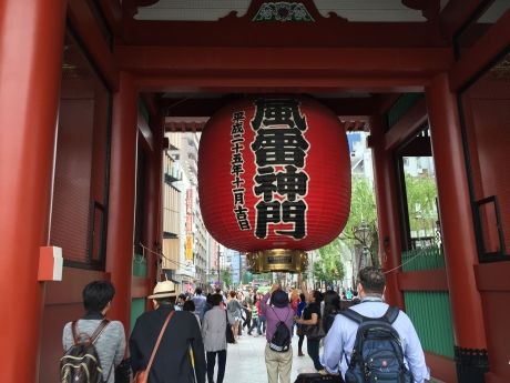 Giant red lantern hanging above crowd of people in Tokyo