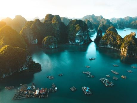 Clear blue water peppered with mountains in Vietnam