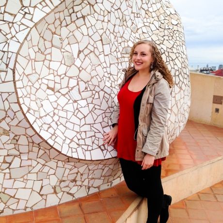 madrid student standing next to art statue