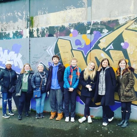 dublin students posing at peace wall