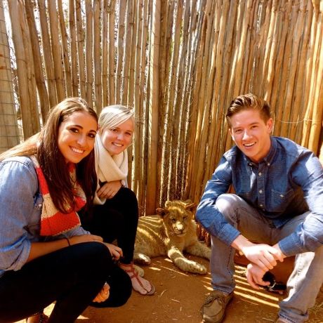 gaborone trio of students sitting in a hut