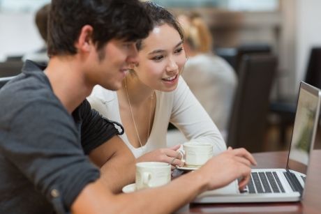 2 students working over laptop