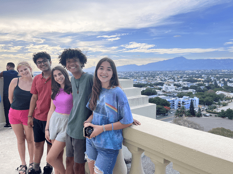 santiago_students-posing-monument.png