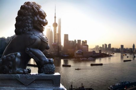 shanghai temple lion in front of the city skyline